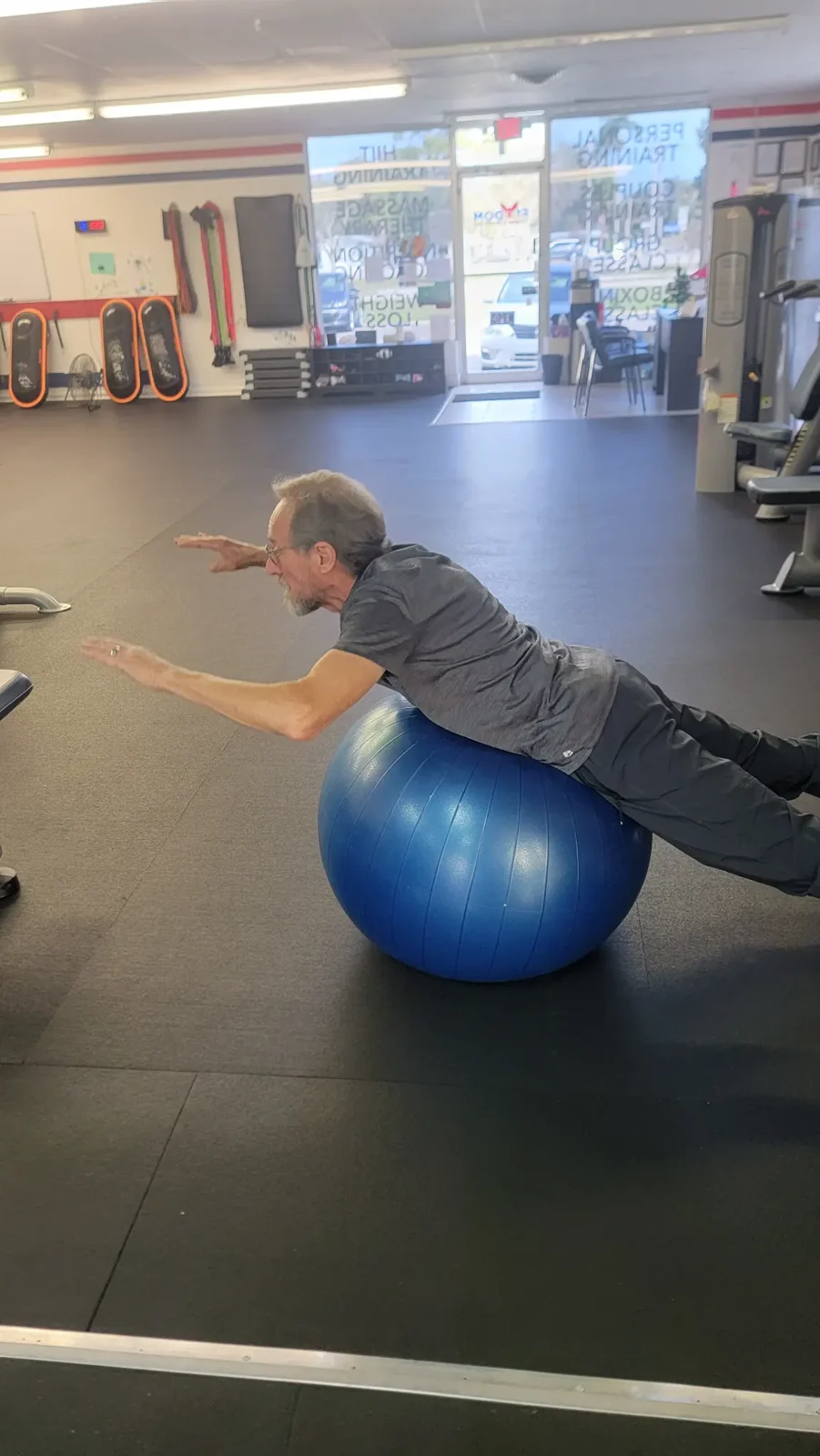 Member practicing balance with a stability ball